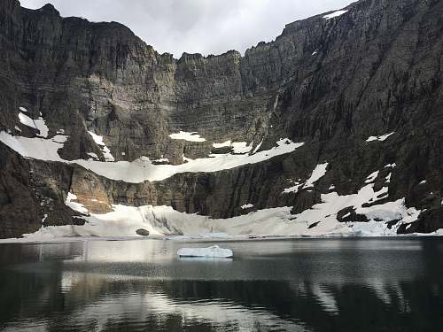 outdoors photo of body of water near mountain snow