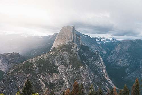 mountain photo of gray mountain under white clouds at daytime crest