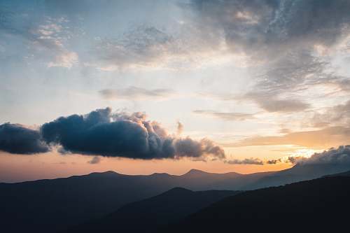outdoors scenery of silhouette of mountains during daytime cloud