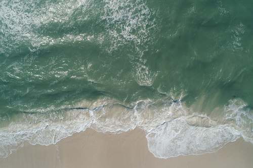 water seawave on seashore with white sand grey
