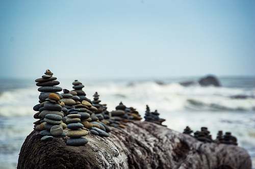 rock shallow focus photography of rock formation coast