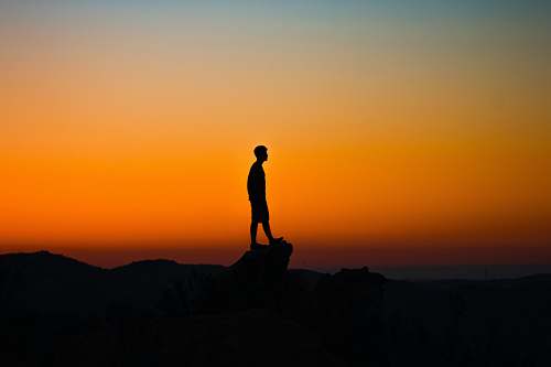 outdoors silhouette of man during sunset sunrise