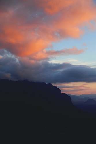 sky silhouette of mountain under clouds sunset