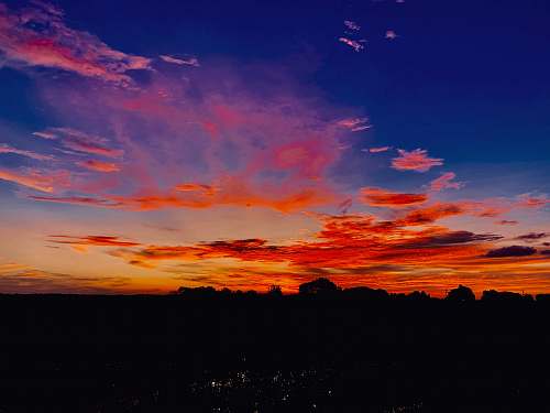 outdoors silhouette photo of orange clouds sunset