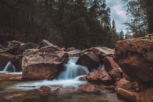water water flowing on brown rocks river