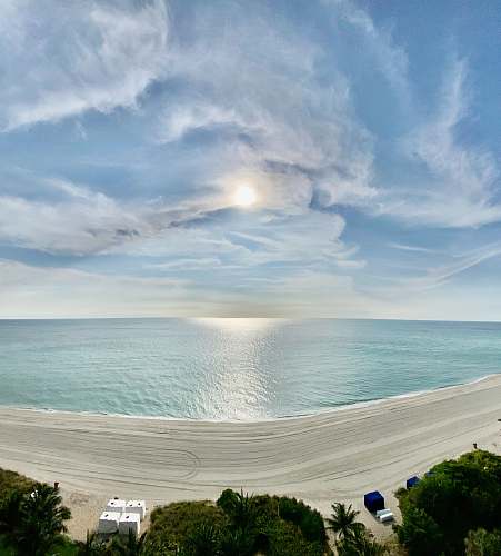 ocean white and blue sky over body of water outdoors
