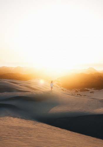 sky woman in white dress standing on sand photo during sunset desert