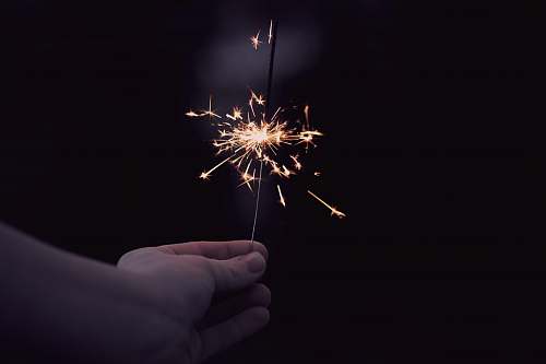 outdoors person holding a sparkler fireworks