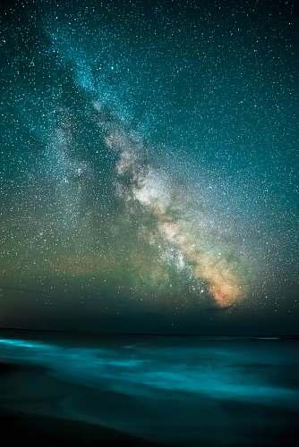 sky stars overlooking body of water during nighttime space