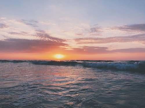 sea body of water at golden hour water