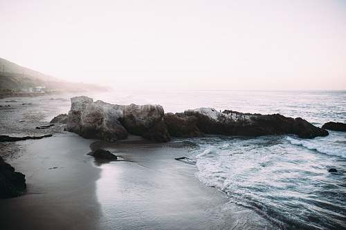 sea grey rock formation at the seashore during daytime water