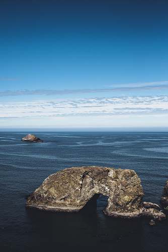 nature rock formation on body of water outdoors
