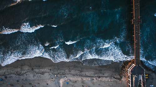 sand black hanging bridge on sea oceanside pier