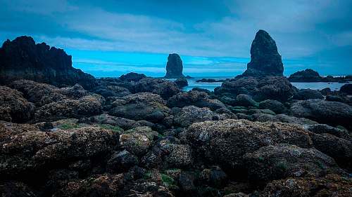ocean gray rock near body of water sea