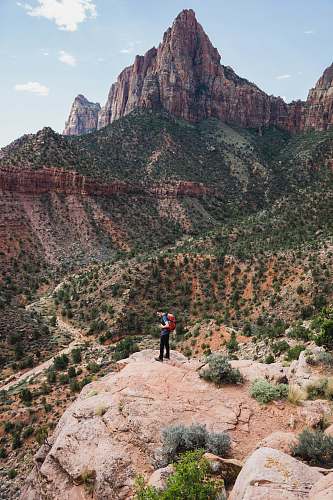 mountain man standing on rock formation nature