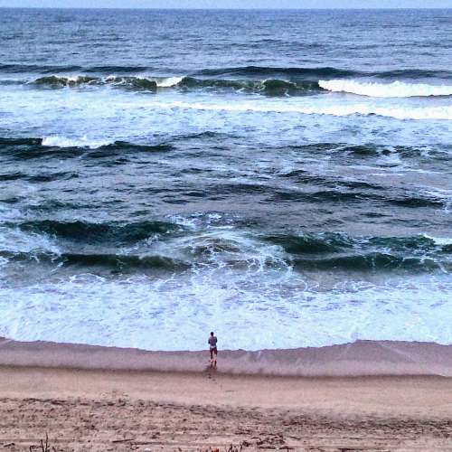 sea man standing seashore water