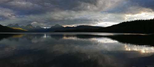 water mountains near body of water under cloudy sky nature