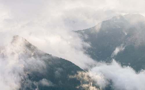 grey mountains with fogs during daytime cloud