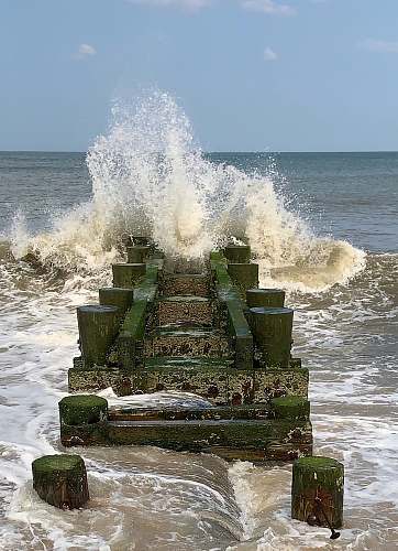 sea water wave beside sea dock ocean