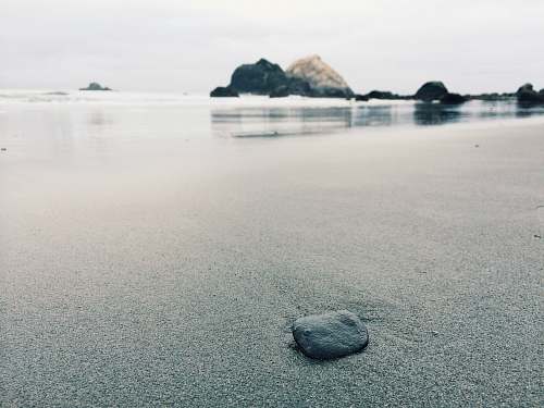 grey black stone on shoreline rock