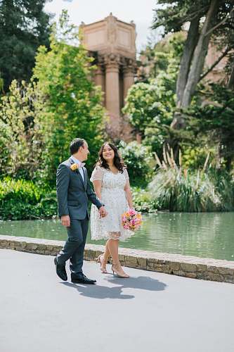person couple walking near pond human
