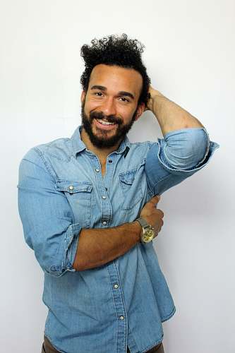 person man holding his hair and chest while looking at the camera human