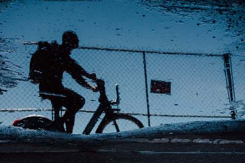 human man on bicycle grayscale photo person