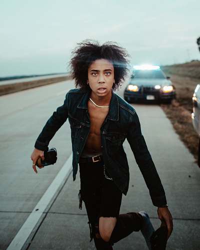 person man standing in the middle of highway human