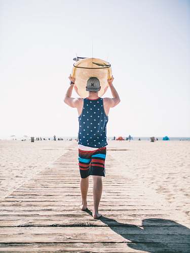 human person holding board on body of water person