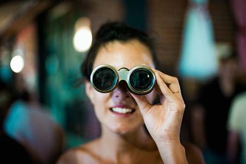 human woman using gray binoculars person