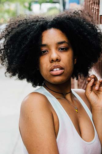 person woman wearing white sleeveless scoop-neck top human