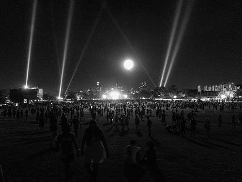black-and-white crowd of people in park at night lighting