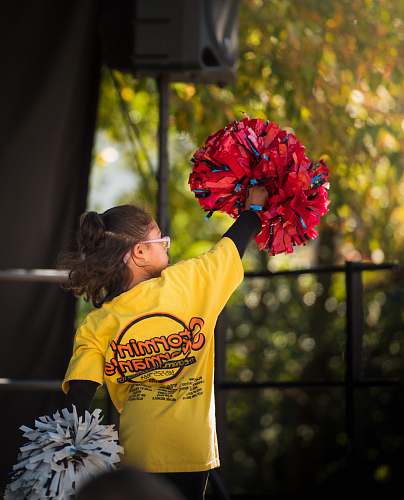 human girl holding cheer dancer pompom plant