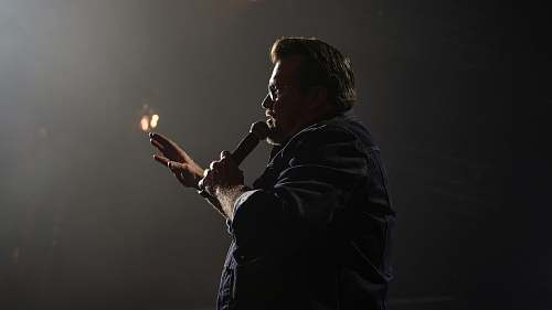 human man in black jacket holding microphone columbus