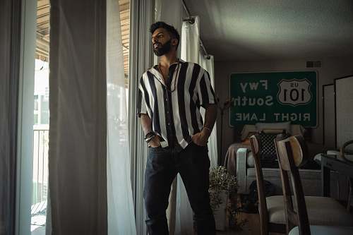 human man leaning on the glass window furniture