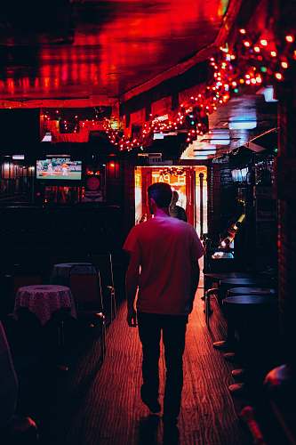 human man walking inside room people