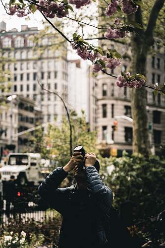 human men holding a camera during daytime new york