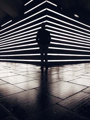 human silhouette photography of standing person flooring