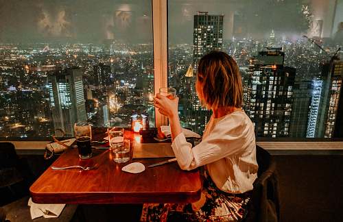 human woman drinking on building furniture