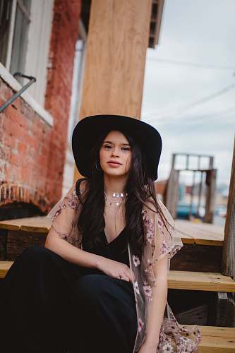 human woman sitting on brown wooden stairs people