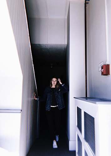 human woman standing beside stairs people