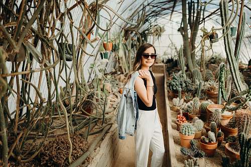 plant women's black tank top and white pants cactus