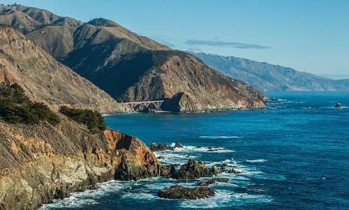 cliff rock mountain beside body of water big sur