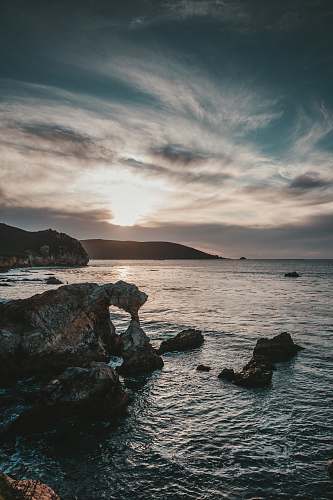 ocean rock near body of water water