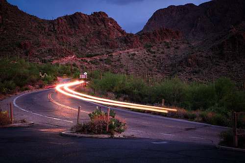 outdoors concrete road beside mountain gates pass