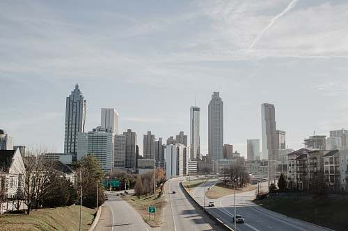 freeway high-rise buildings during daytime highway