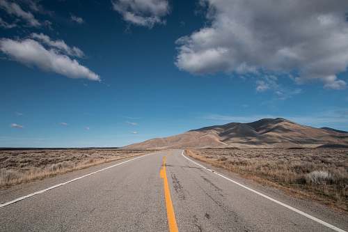 sky selective focus photo of road under blue sky idaho