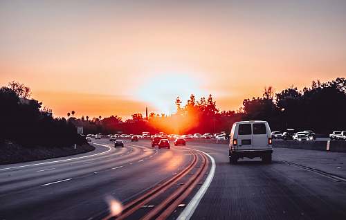sunset white van on grey concrete road during golden hour freeway