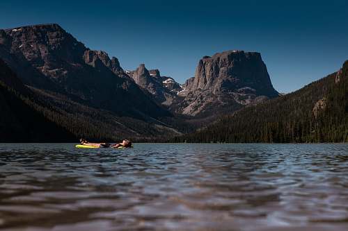 vessel boat with view of rocky mountains watercraft