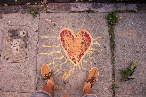 pavement person standing near heart paint san francisco